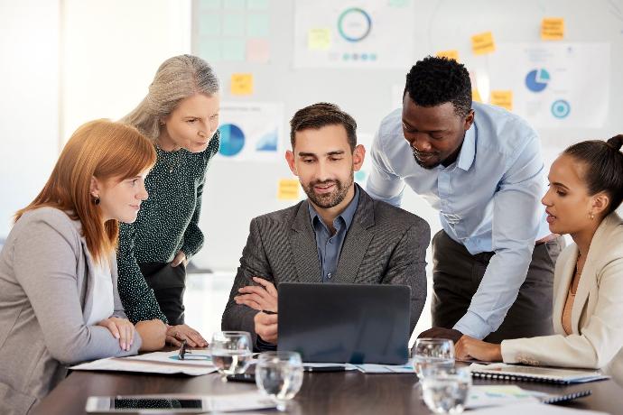 Group of people looking laptop